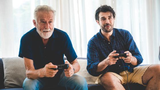 Father and older son playing computer game